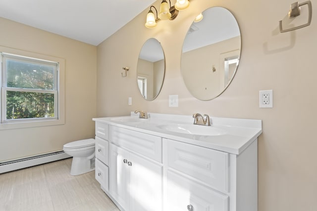 2 Mountain View Ln, Readfield, ME 04355 - bathroom featuring double vanity, a sink, a baseboard heating unit, and toilet
