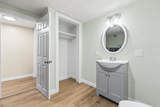 2 Mountain View Ln, Readfield, ME 04355 - bathroom featuring vanity, a textured ceiling, baseboards, and wood finished floors