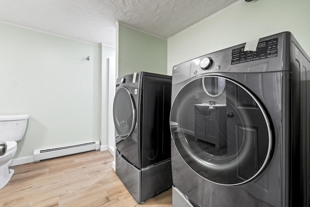 2 Mountain View Ln, Readfield, ME 04355 - clothes washing area with independent washer and dryer, light wood-style flooring, crown molding, laundry area, and a baseboard heating unit