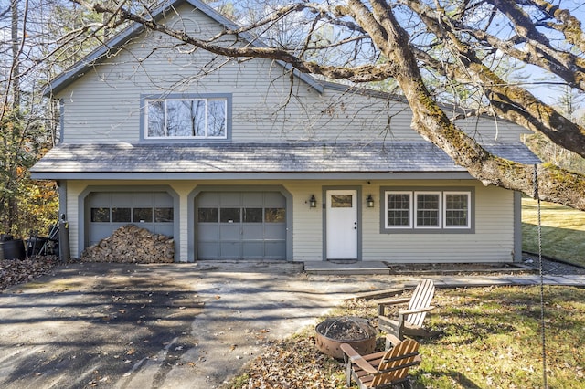 2 Mountain View Ln, Readfield, ME 04355 - view of front of house featuring a fire pit, an attached garage, and aphalt driveway