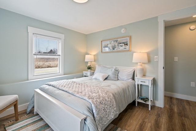 bedroom featuring baseboards and wood finished floors