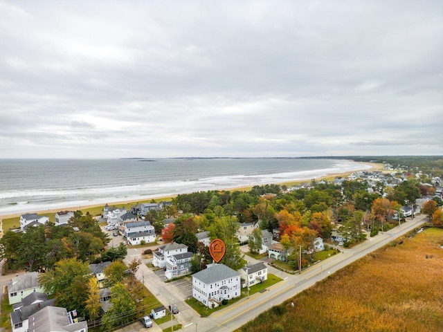 drone / aerial view featuring a water view and a beach view