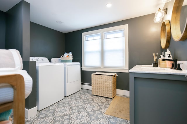 laundry area with laundry area, a sink, baseboard heating, separate washer and dryer, and recessed lighting