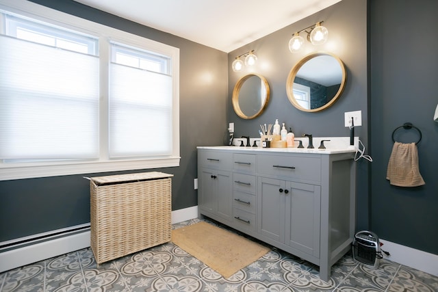 full bathroom featuring double vanity, tile patterned flooring, a sink, baseboards, and a baseboard heating unit
