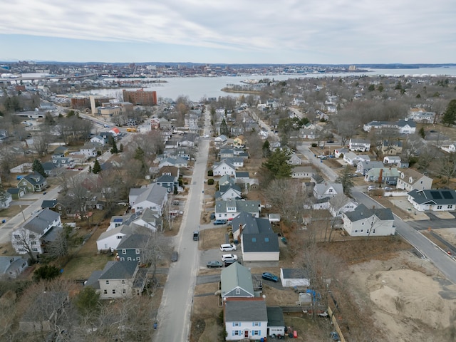 birds eye view of property with a water view and a residential view