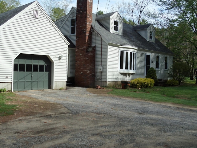 365 Country Club 3rd Rd, Sanford, ME 04073 - view of property exterior featuring a chimney, driveway, and a garage