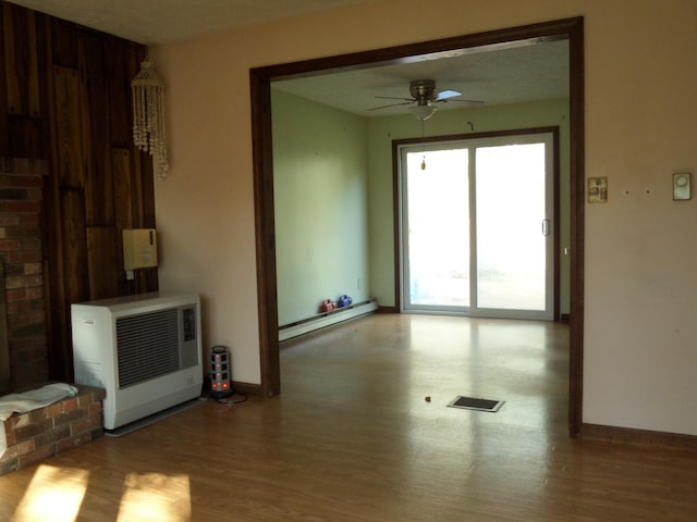 365 Country Club 3rd Rd, Sanford, ME 04073 - empty room with heating unit, a baseboard radiator, wood finished floors, ceiling fan, and baseboards