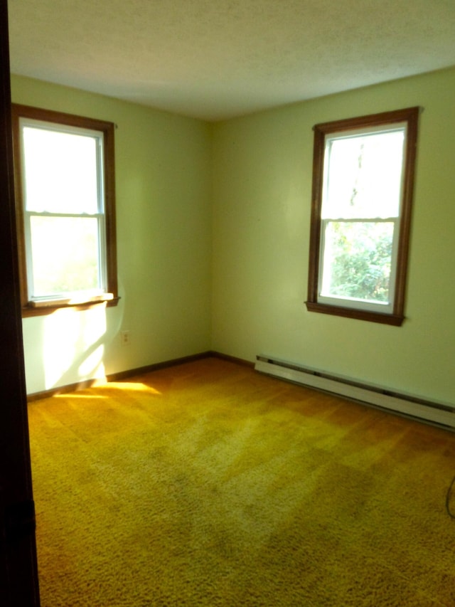 365 Country Club 3rd Rd, Sanford, ME 04073 - empty room with healthy amount of natural light, baseboard heating, light colored carpet, and baseboards