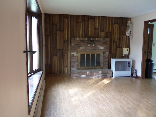 365 Country Club 3rd Rd, Sanford, ME 04073 - unfurnished living room with wood walls, wood finished floors, a fireplace, and heating unit
