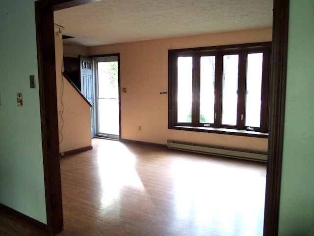365 Country Club 3rd Rd, Sanford, ME 04073 - unfurnished room with baseboard heating, wood finished floors, and baseboards
