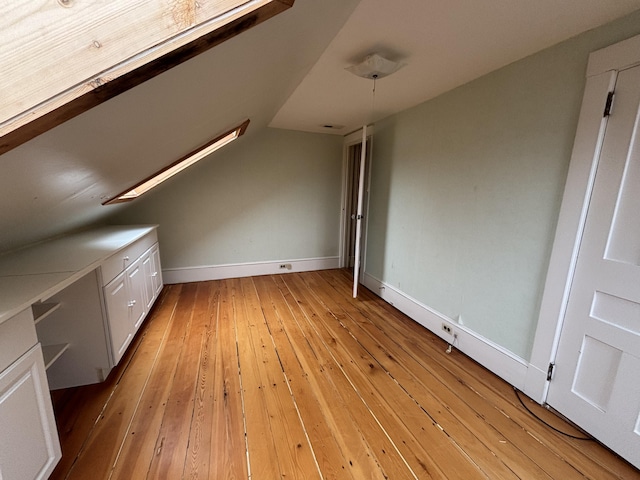 20 Water St, Winterport, ME 04496 - bonus room with lofted ceiling, baseboards, and light wood finished floors