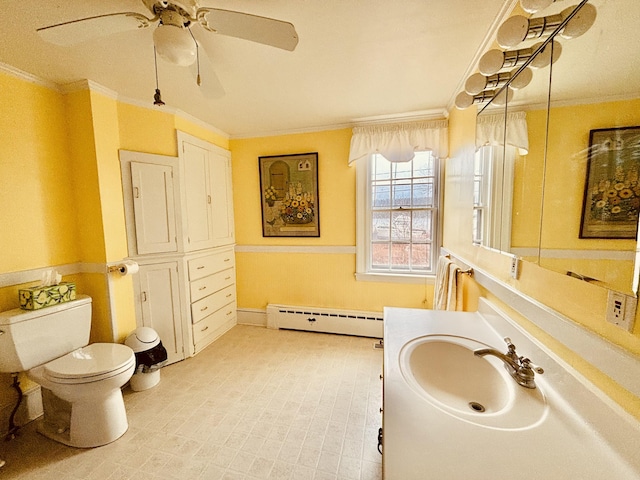 20 Water St, Winterport, ME 04496 - bathroom featuring crown molding, toilet, vanity, a ceiling fan, and baseboard heating