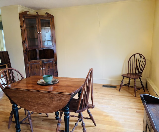 20 Water St, Winterport, ME 04496 - dining space with ornamental molding, baseboards, visible vents, light wood-style flooring, and baseboard heating