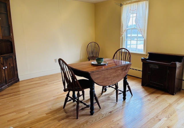 20 Water St, Winterport, ME 04496 - dining area featuring baseboards, a baseboard heating unit, and light wood-style floors