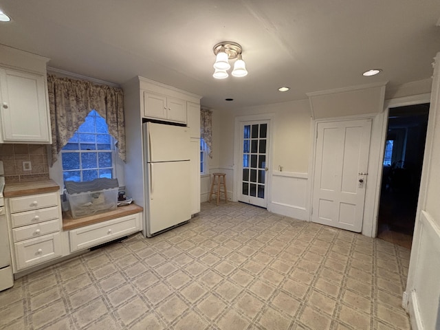 20 Water St, Winterport, ME 04496 - kitchen featuring freestanding refrigerator, white cabinets, light countertops, and light floors