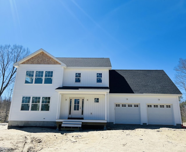 modern farmhouse style home featuring a garage, covered porch, a shingled roof, and driveway