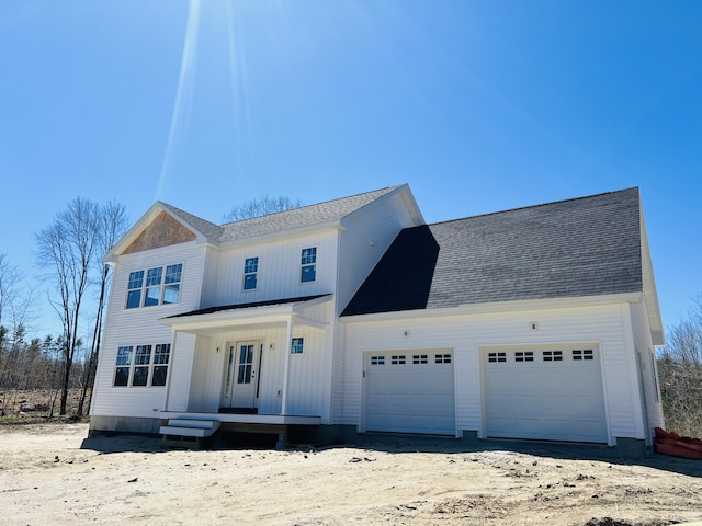 modern farmhouse style home featuring driveway, a shingled roof, and a garage