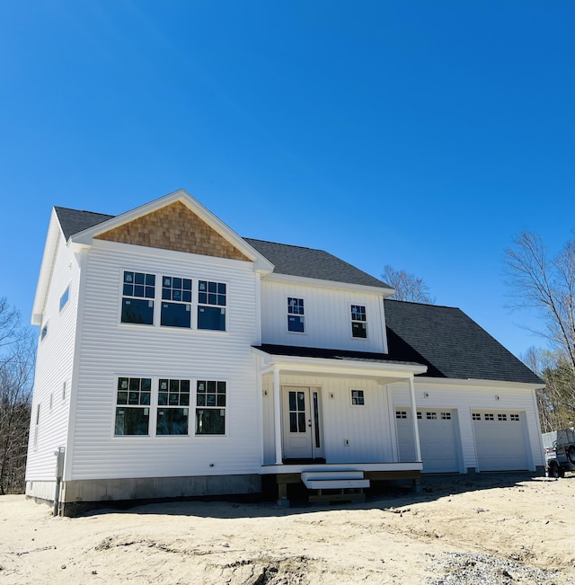 view of front of house featuring an attached garage and a porch