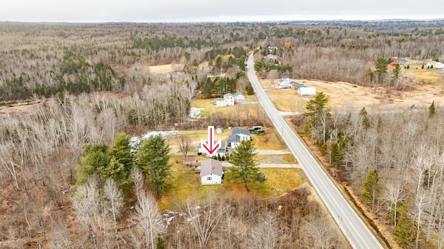 drone / aerial view featuring a wooded view