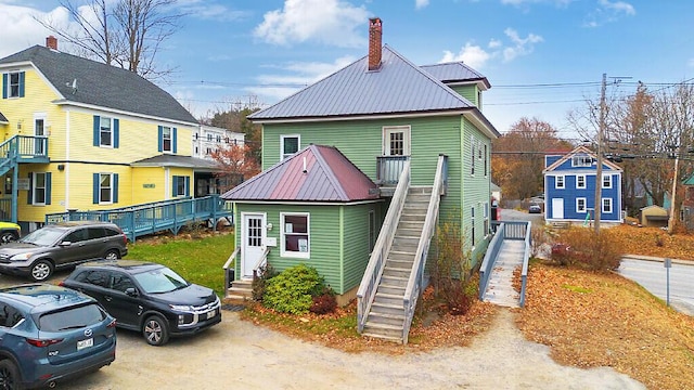86 Western Ave, Augusta, ME 04330 - exterior space with a chimney, entry steps, stairway, and metal roof
