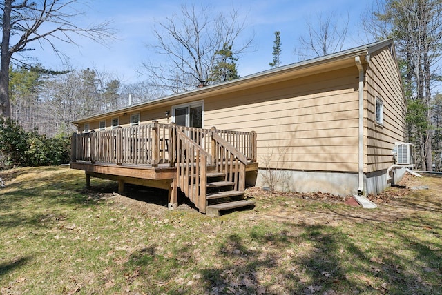back of house featuring a wooden deck and a yard