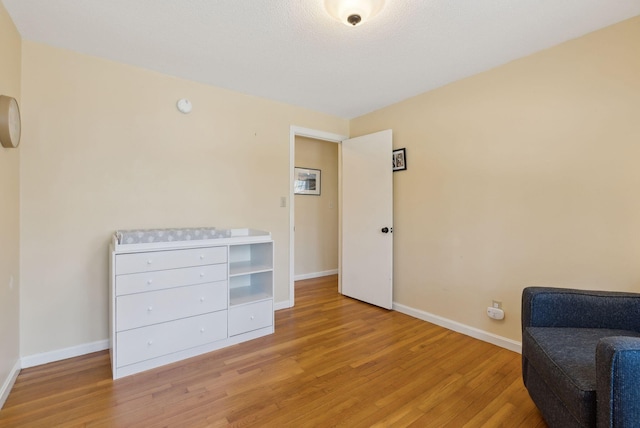sitting room featuring light wood-style flooring and baseboards