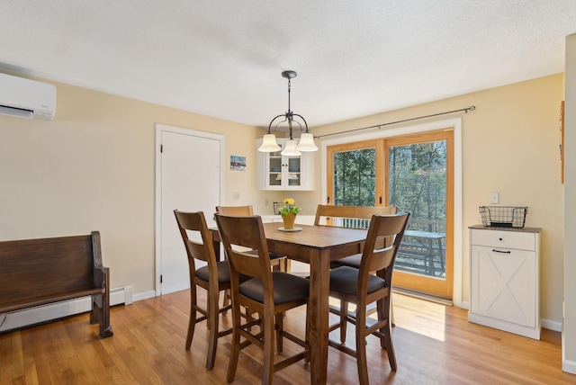 dining space with baseboard heating, baseboards, light wood finished floors, and a wall unit AC