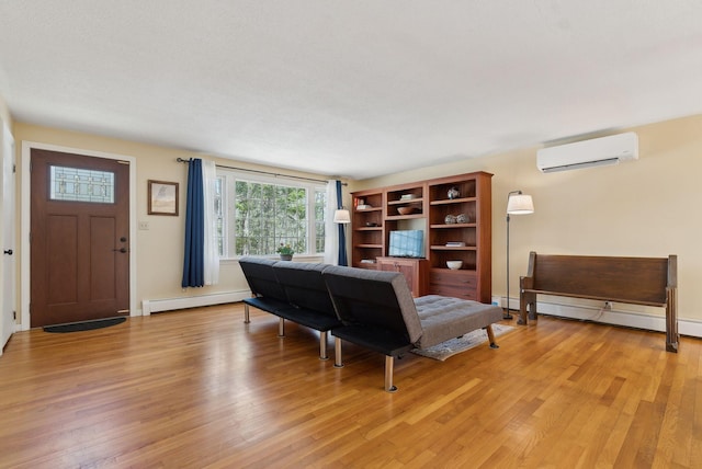 living area with light wood finished floors, a baseboard heating unit, baseboards, a baseboard radiator, and a wall mounted AC
