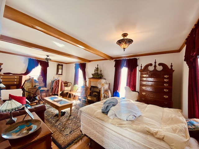 bedroom featuring a fireplace, crown molding, multiple windows, and beamed ceiling