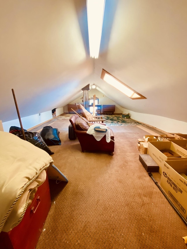 unfurnished bedroom featuring carpet flooring and lofted ceiling with skylight