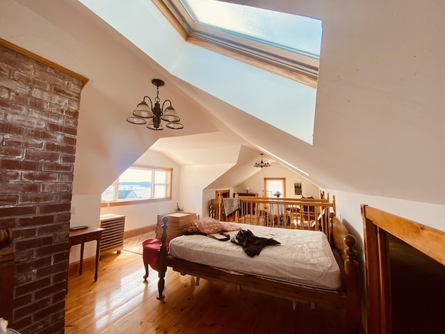 bedroom featuring baseboards, vaulted ceiling, a notable chandelier, and wood-type flooring