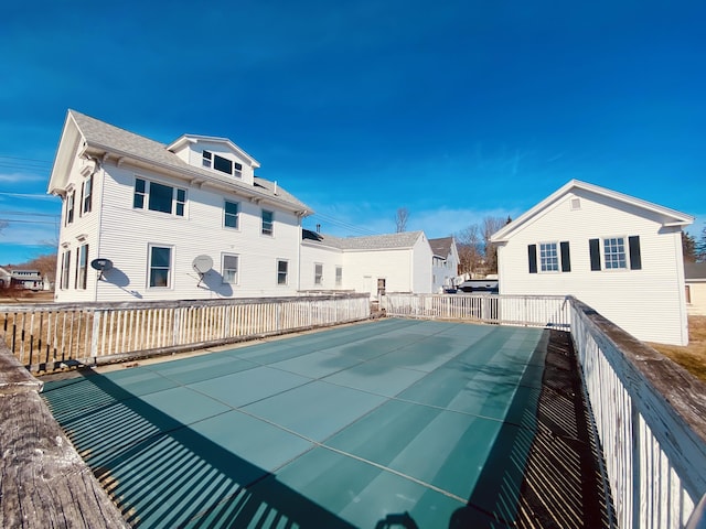 view of swimming pool with fence