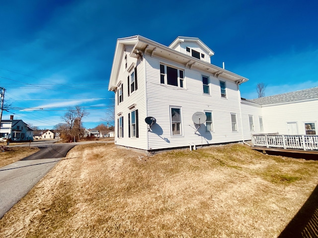 rear view of property featuring a lawn