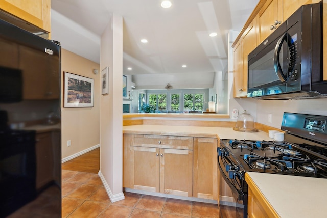 kitchen with baseboards, recessed lighting, black appliances, light countertops, and light tile patterned floors
