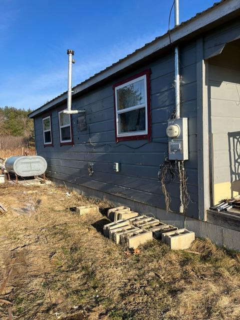 view of side of home featuring heating fuel