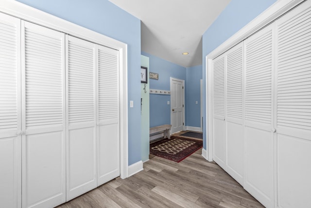 hallway featuring recessed lighting, baseboards, wood finished floors, and a baseboard radiator