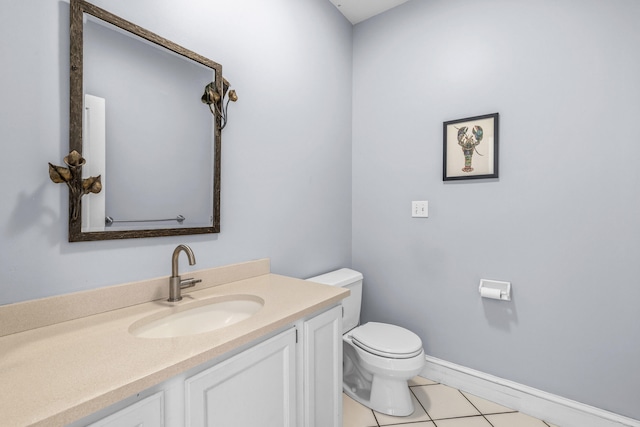 half bathroom featuring vanity, tile patterned flooring, baseboards, and toilet