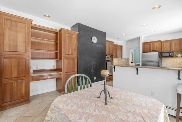 dining room featuring recessed lighting, light tile patterned floors, and a baseboard radiator