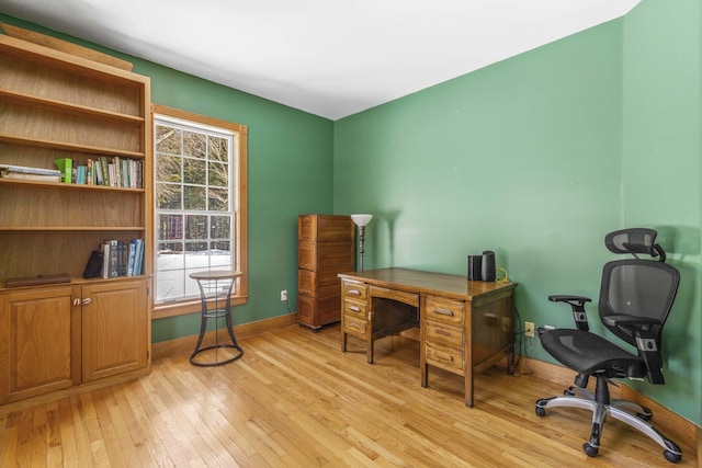 office area featuring baseboards and light wood-style flooring