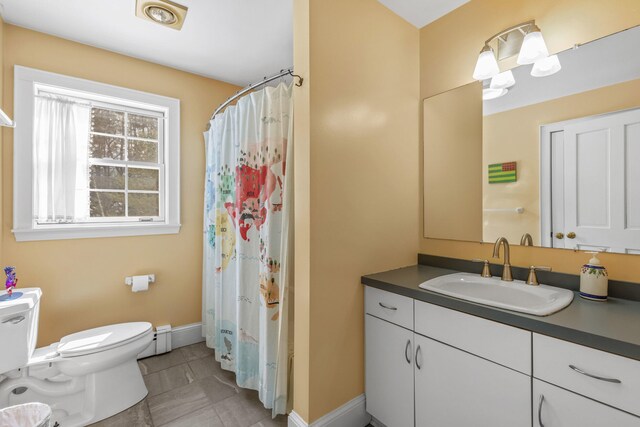 full bathroom featuring tile patterned flooring, vanity, baseboards, a baseboard heating unit, and toilet