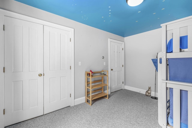 bedroom with carpet floors and baseboards