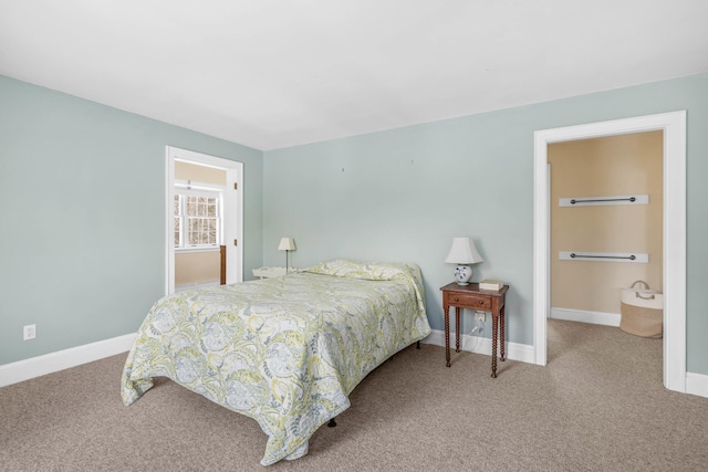 carpeted bedroom featuring baseboards