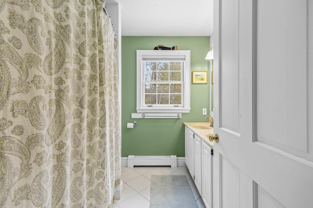 full bathroom featuring tile patterned floors, a baseboard radiator, baseboards, and vanity