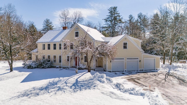 view of front of home with a chimney and a garage