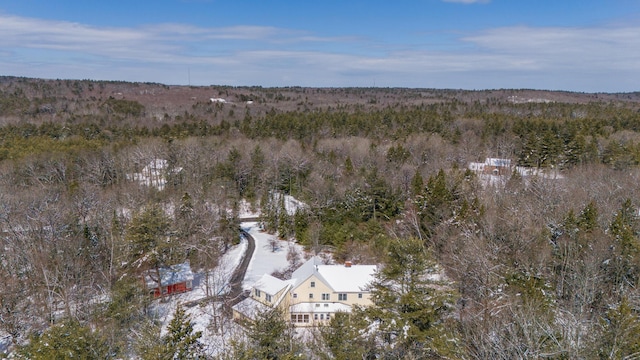 snowy aerial view featuring a view of trees