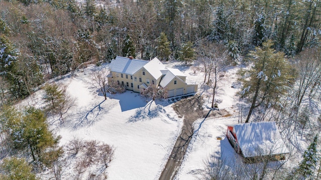snowy aerial view with a view of trees