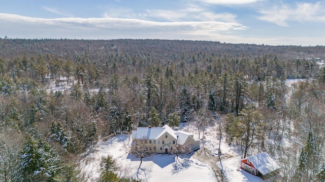birds eye view of property with a wooded view