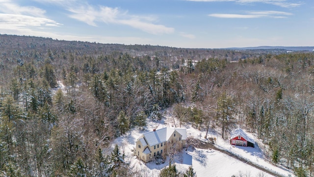 bird's eye view with a wooded view