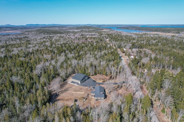 birds eye view of property featuring a view of trees