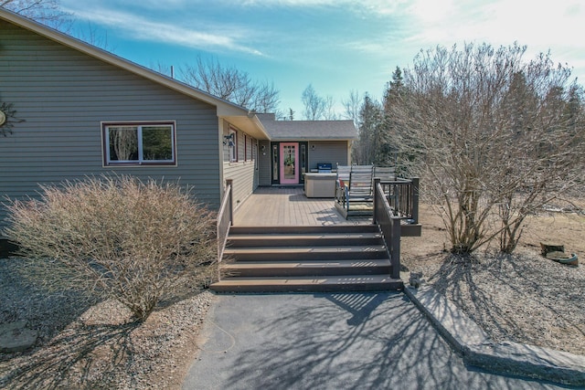 rear view of property featuring a deck